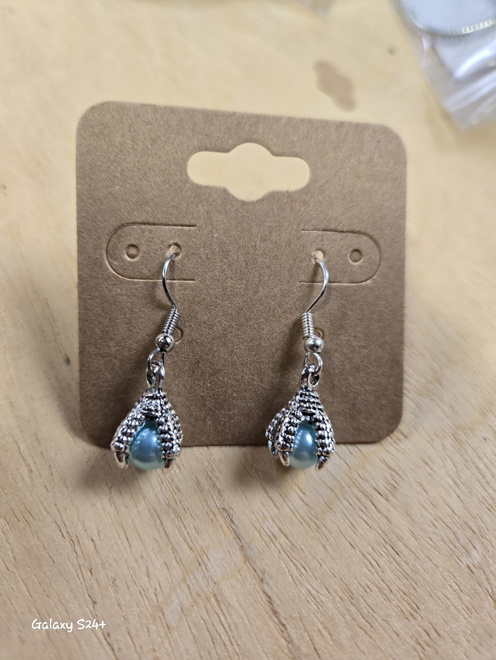 Handmade Dangle Talon Gripping Blueish Bead.